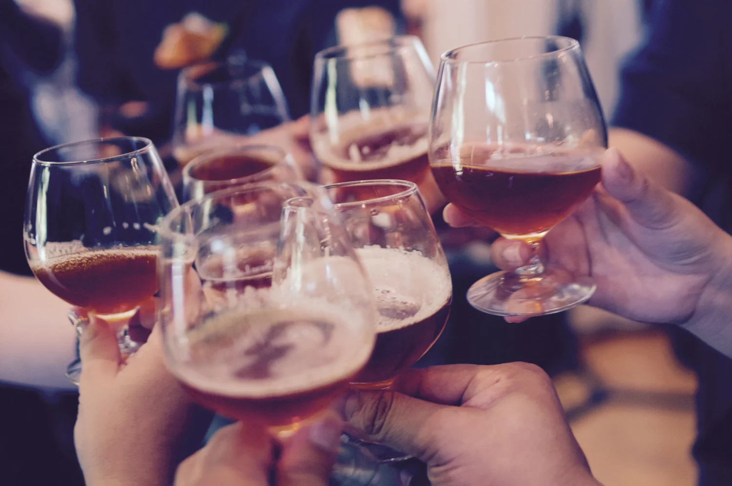 Friends clinking beer and cocktail glasses at happy hour